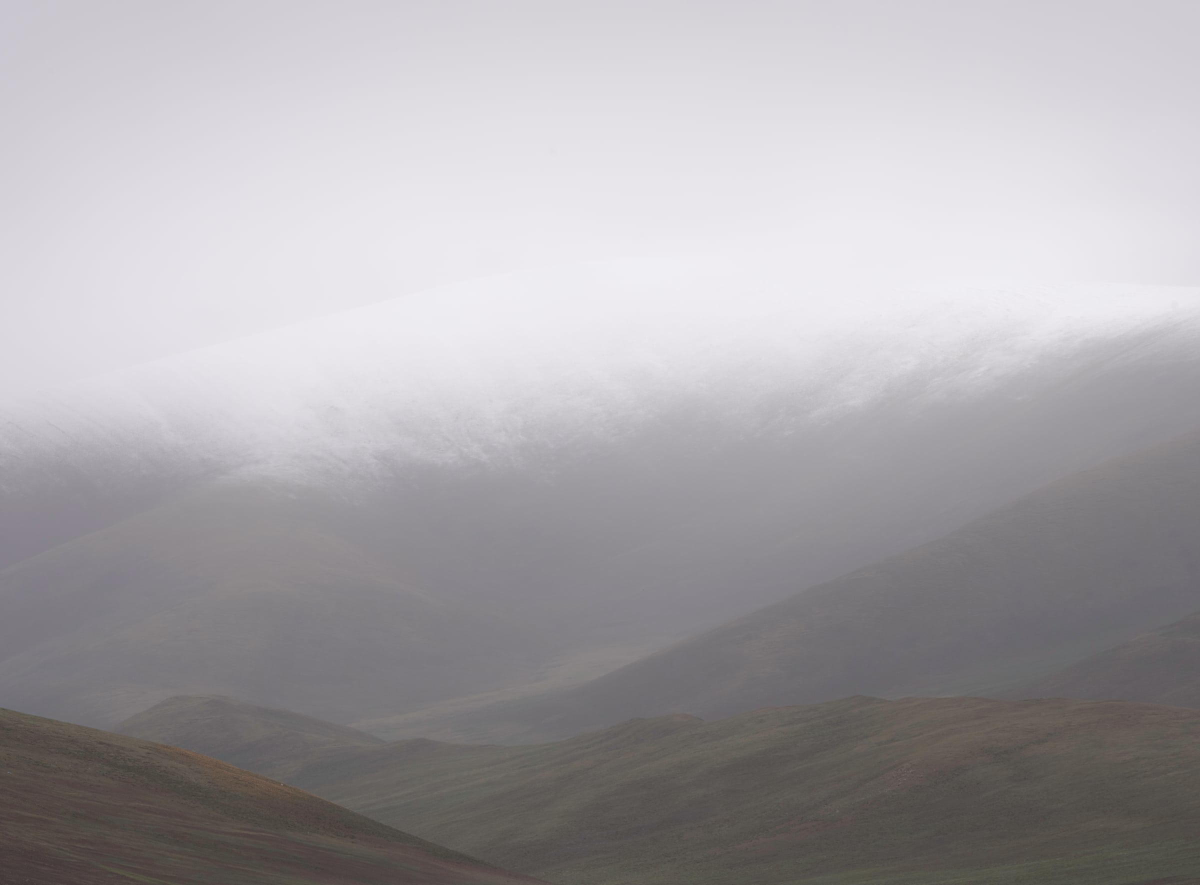 Mountain ridges fading into mist